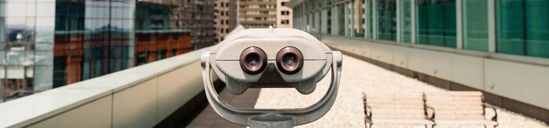 binoculars in city 1132 x 264