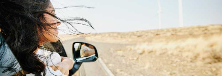 woman looking out car window desert hero mobile 750 x 259