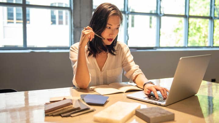 Young Woman Working At The Table 718 x 404