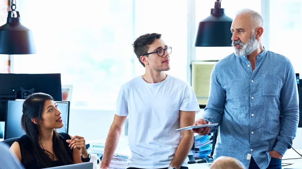 Several professionals discussing ideas in a collaborative office environment