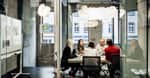 young people talking around a table s