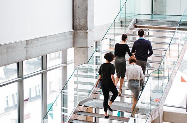 Rear View Of Young Business people Walking 604x398