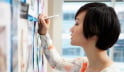 Woman writing on a whiteboard