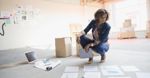 Businesswoman Reviewing Paperwork On Floor 560x292