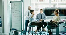 Businesswoman Leading Meeting In Office 225x121