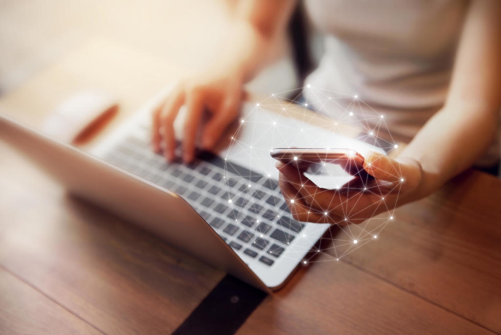 Woman Using Mobile Phone And Laptop 1024px 11002
