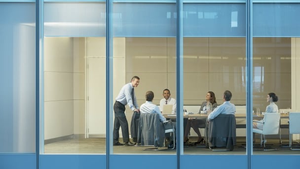 Private equity and venture capital business people talking in a conference room.