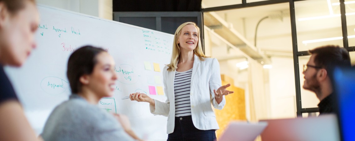 Businesswoman giving presentation on future plans to colleagues.jpg