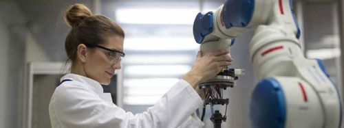 Female Engineer Working With Robotic Arm 753x282