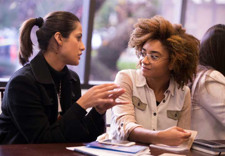two women talking 720x500