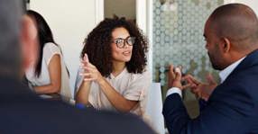 Businesspeople Explaining At Meeting meta 560x292